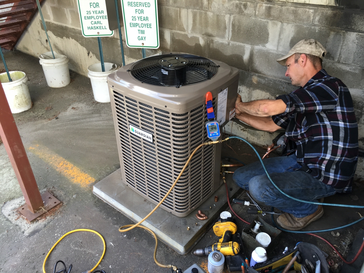 HPA Service Tech working on a Air Conditioning unit